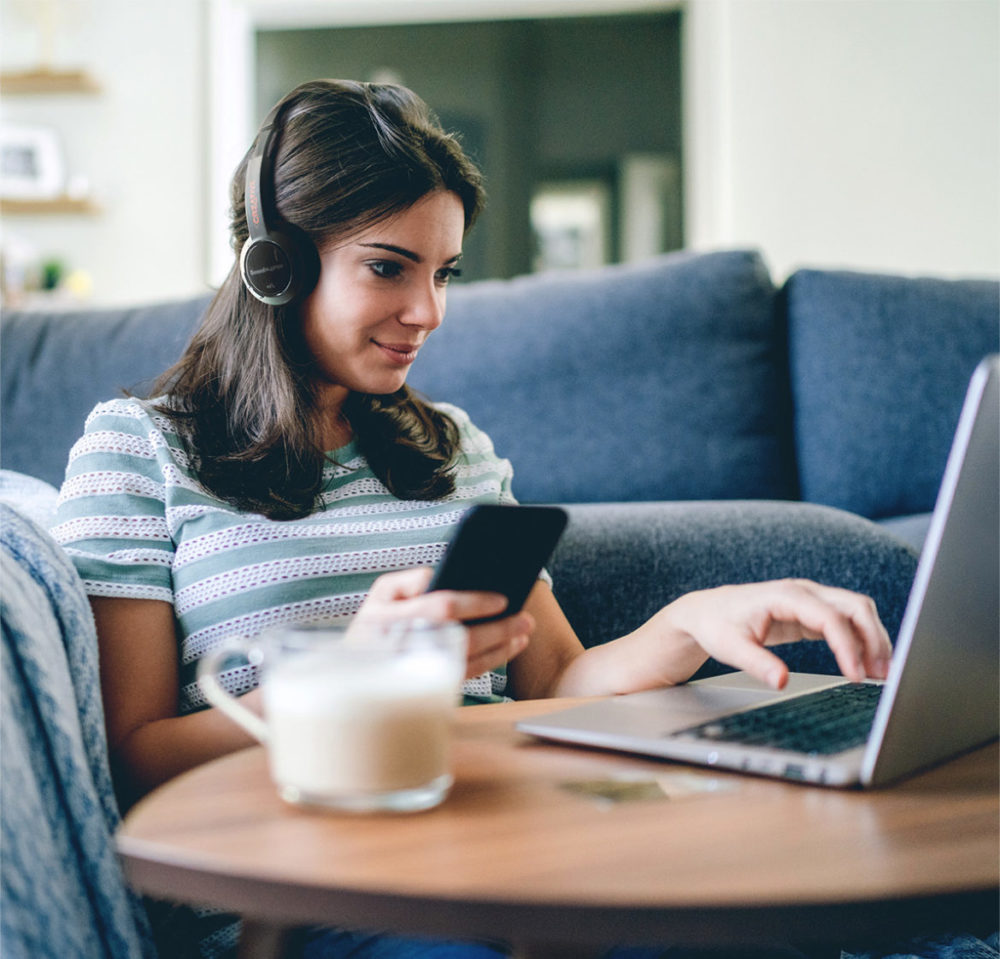 Creative Sound Blaster JAM V2 life style woman using phone and computer